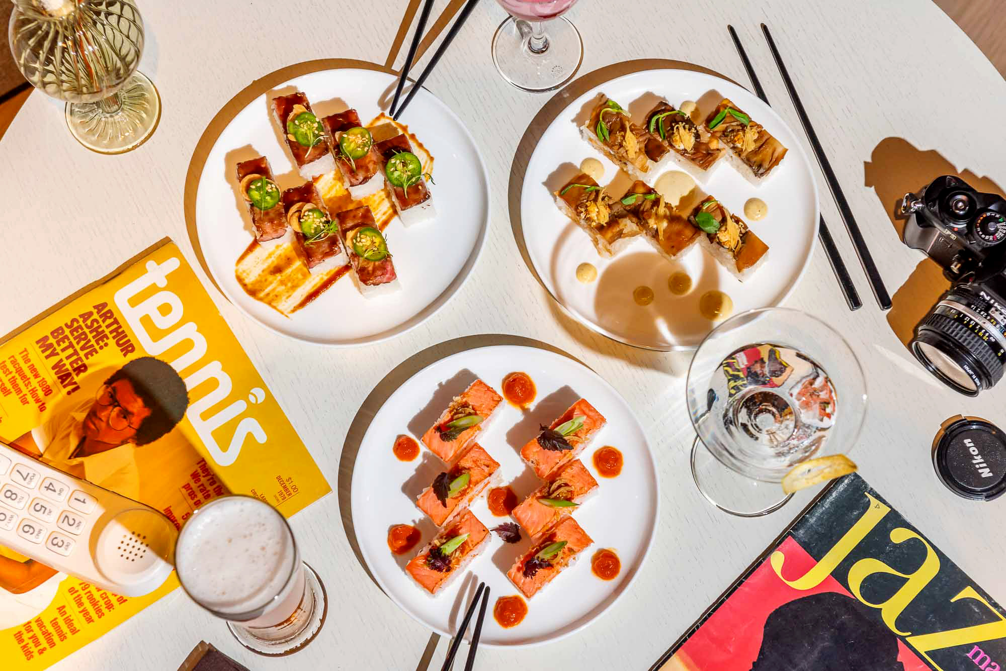 Flatlay of plates pressed sushi on a white table at The Joneses restaurant downtown Toronto